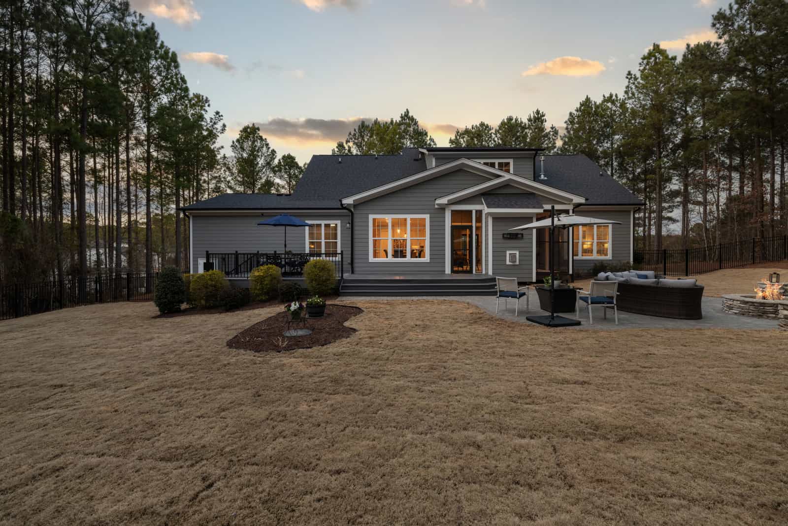 A quiet suburban backyard lawn at dusk